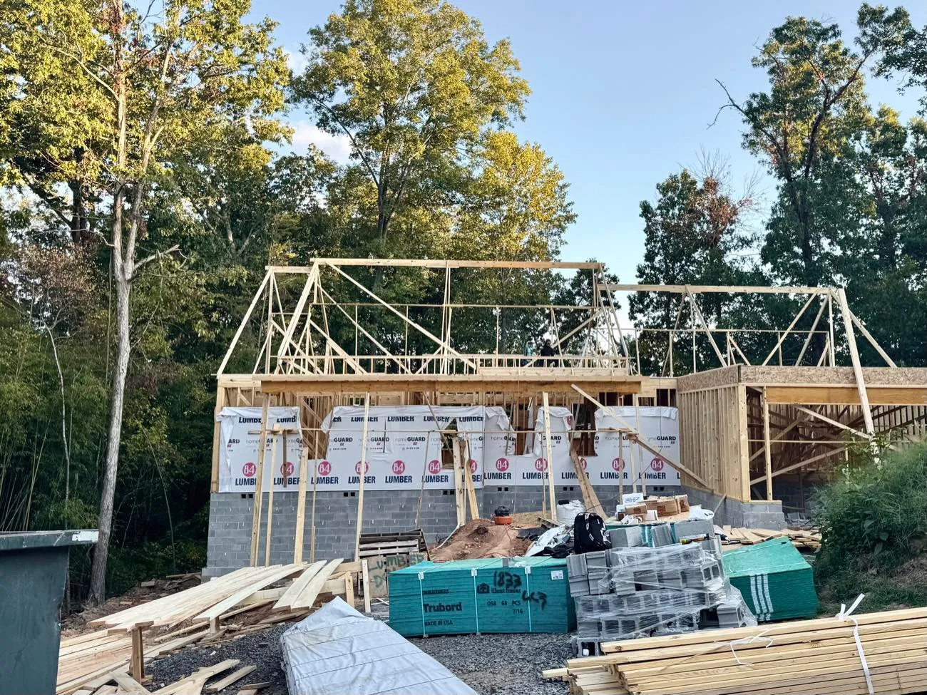 Timber framing and roof trusses going up on a new home under construction