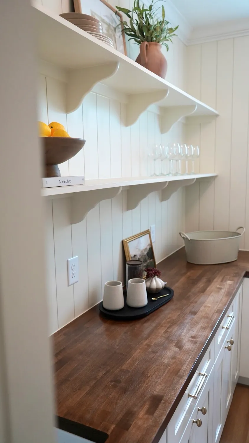 Pantry with open shelves on brackets, vertical shiplap walls and a butcher-block countertop